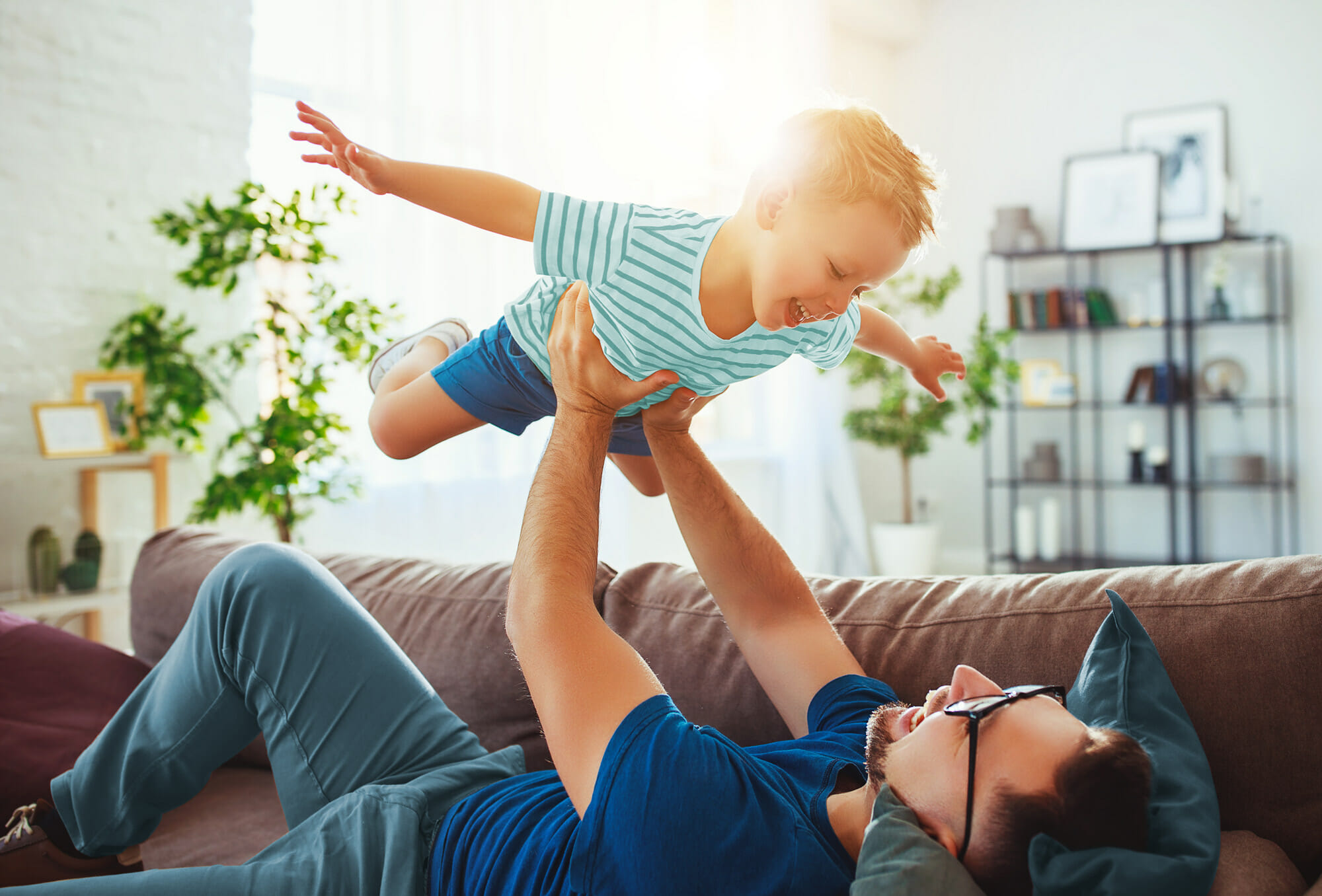 Financial Planning - Father and Son Enjoying Playtime Together