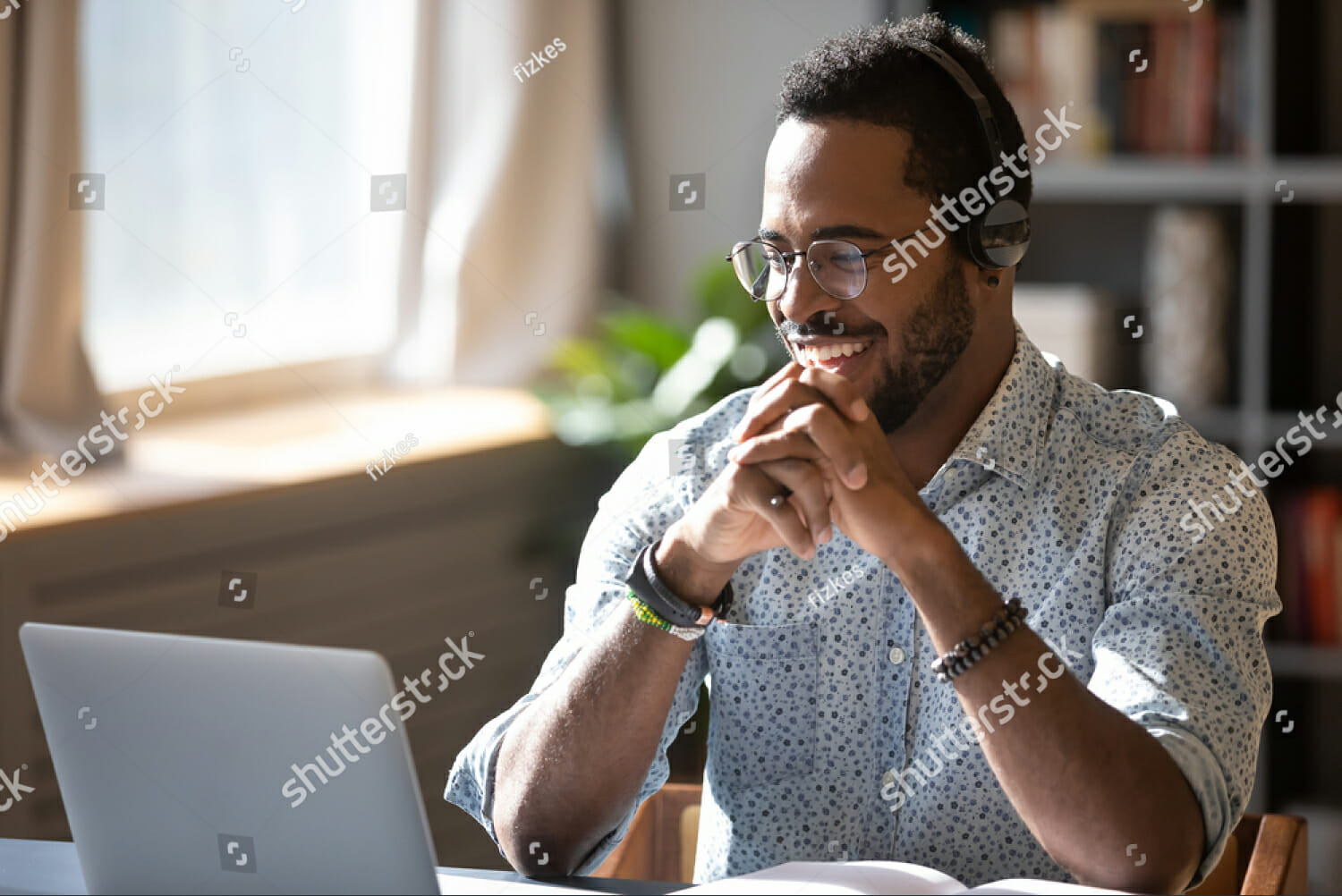 stock-photo-happy-millennial-african-american-man-in-glasses-wearing-headphones-enjoying-watching-educational-1660490494