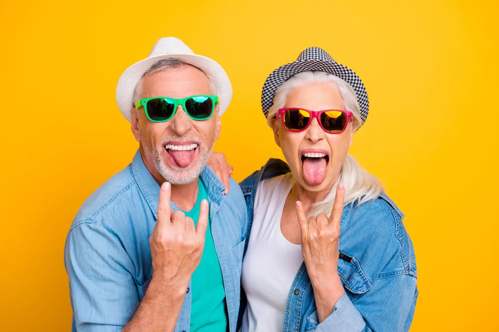 Retirement Workshop - Cheerful Elderly Couple Posing for Photo Against Yellow Background